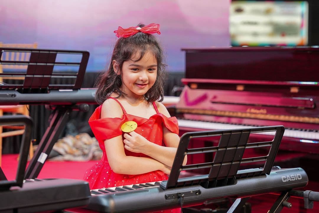 A young BodhiTree student performing on keyboard at a recital